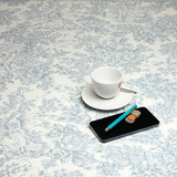 Living Toile de Jouy: Wipe Clean Tablecloth. Pictured with a cup and saucer, 'phone, pen and coins.