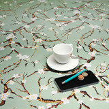 Living Sakura: Wipe Clean Tablecloth. Pictured with a cup and saucer, 'phone, pen and coins.