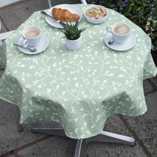 Wipe Clean Tablecloth - Blaze: Sprig Sage on a small bistro style table