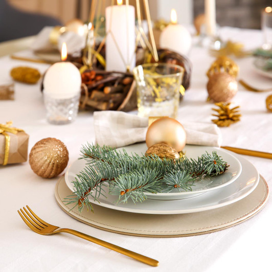 Beautiful Christmas table setting with a white tablecloth