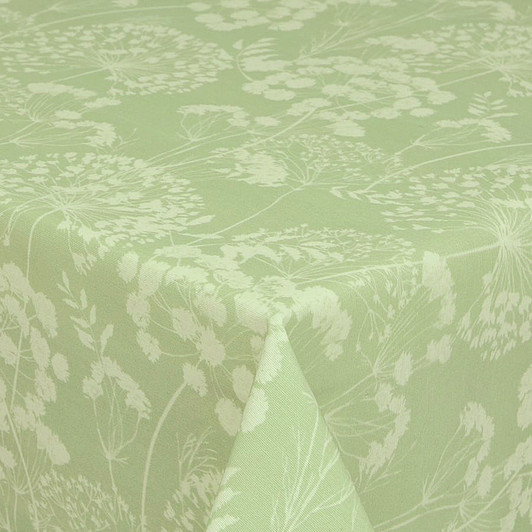 Wipe-clean Fabric: Navarra: Ceres Verde. Pictured draped on the corner of a dining table.
