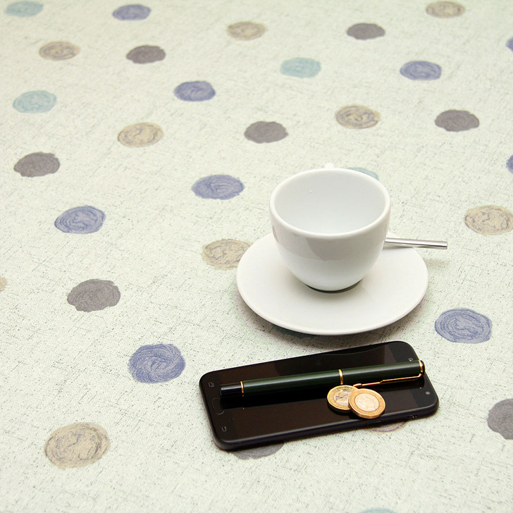 Acrylic Coated Tablecloth Loneta: Leon - Blue. Pictured with a cup and saucer, 'phone and pen.