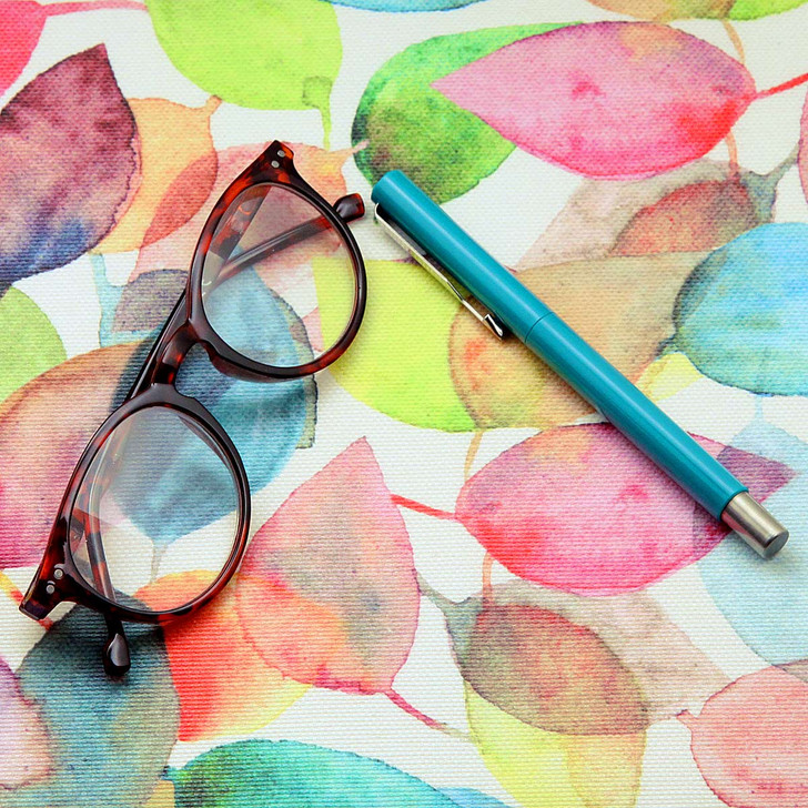 Wipe Clean Tablecloth: Digital Paris. Pictured with a pair of glasses and a pen.
