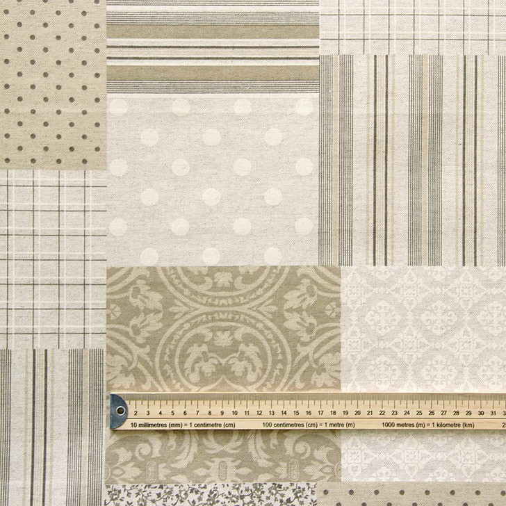 Wipe Clean Tablecloth Fabric. Mirha: Patchwork - Pictured with a wooden ruler