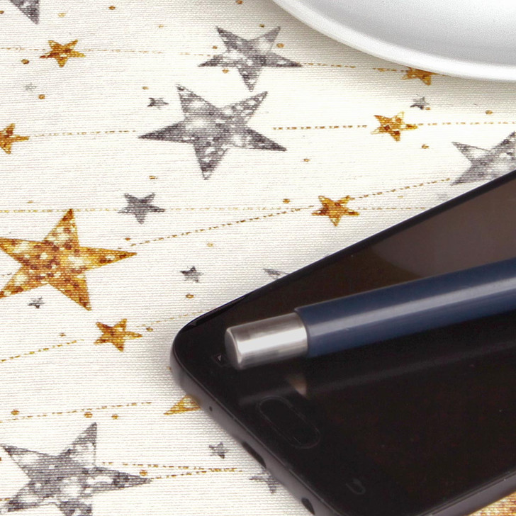 Navarra Silver & Gold Stars Acrylic Coated Fabric. Pictured close up.