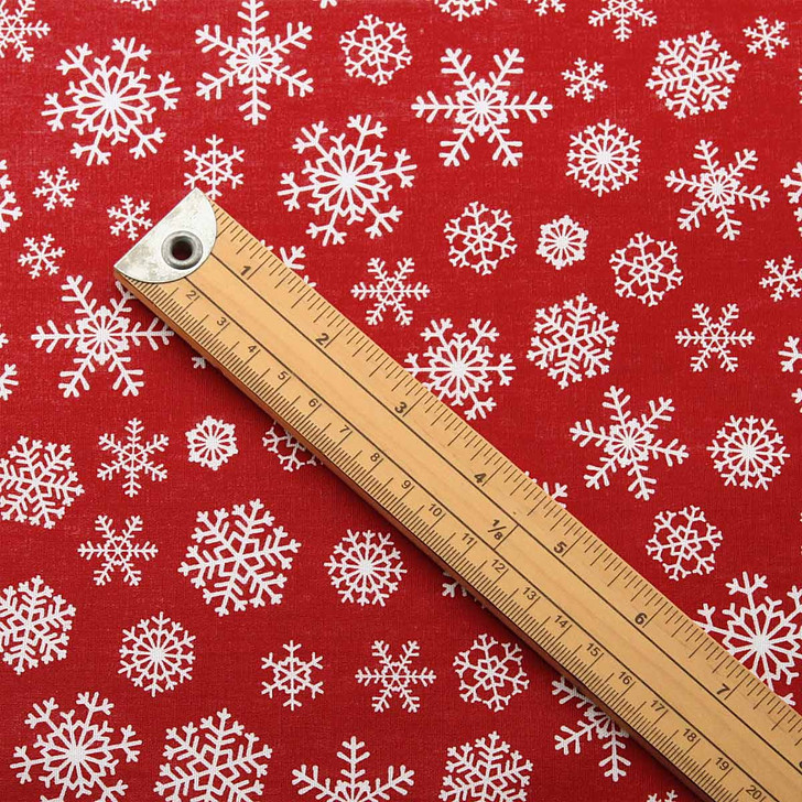 Symphony: Snowflake Acrylic Coated Fabric - pictured with a wooden metre rule to show scale.