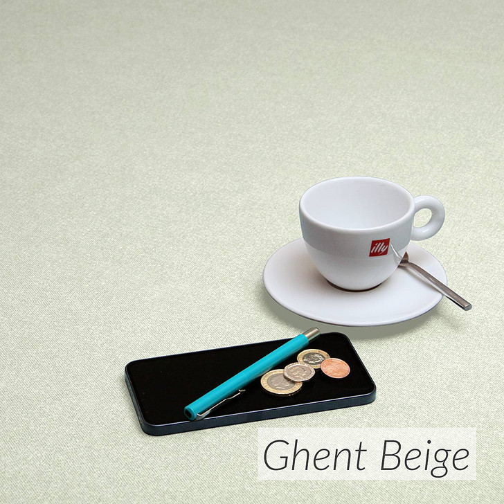 Loneta Dali Extra Wide Wipe Clean Tablecloth: Ghent Beige - pictured with a cup and saucer, 'phone, pen and coins.