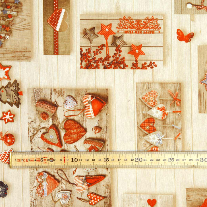 Navarra Love Christmas Acrylic Coated Fabric. Pictured with a wooden rule.