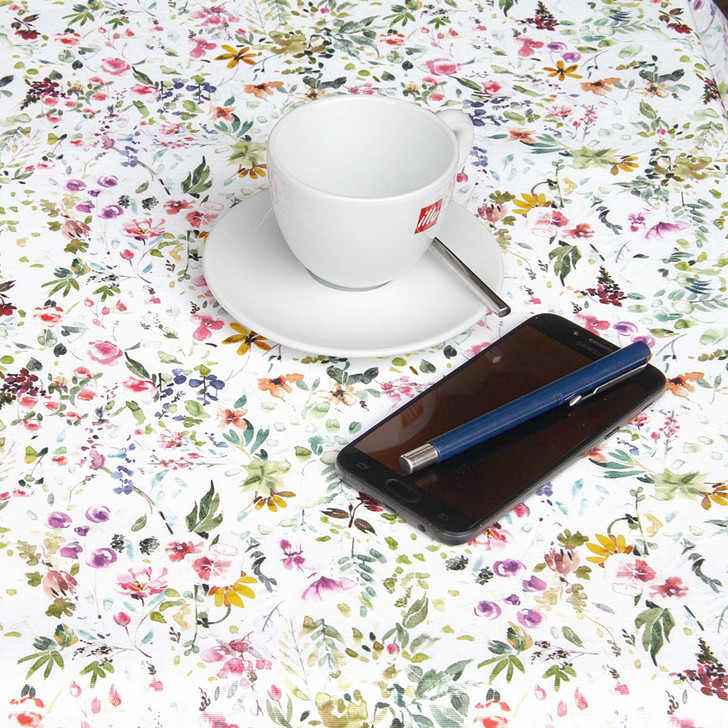 Wipe Clean Tablecloth - Digital Amelie. Pictured on a table with a cup and saucer, 'phone and pen.
