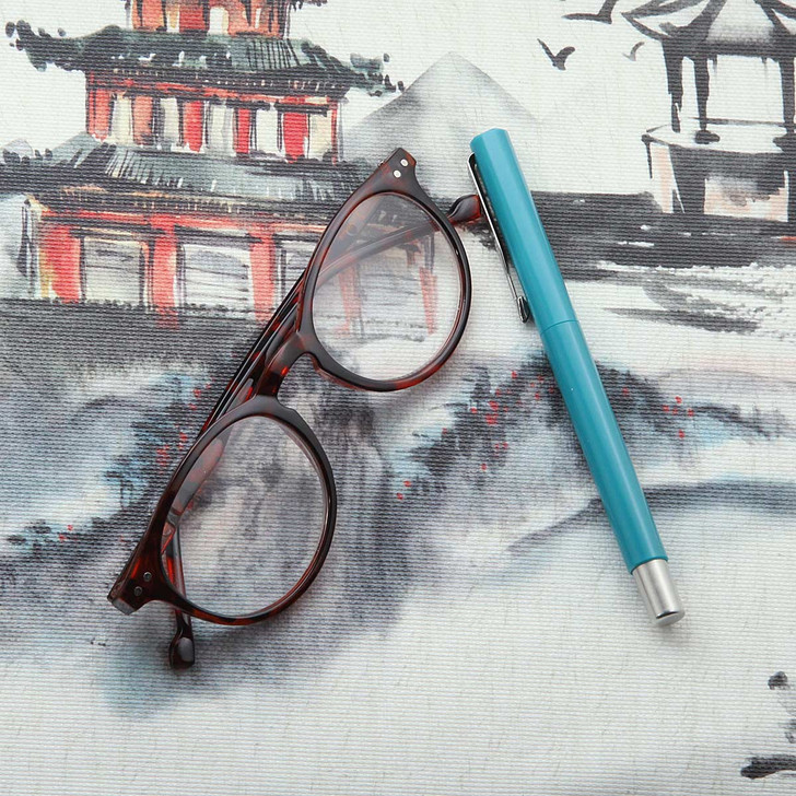 Wipe Clean Tablecloth - Digital Tokyo. Pictured with a pair of glasses and a pen.
