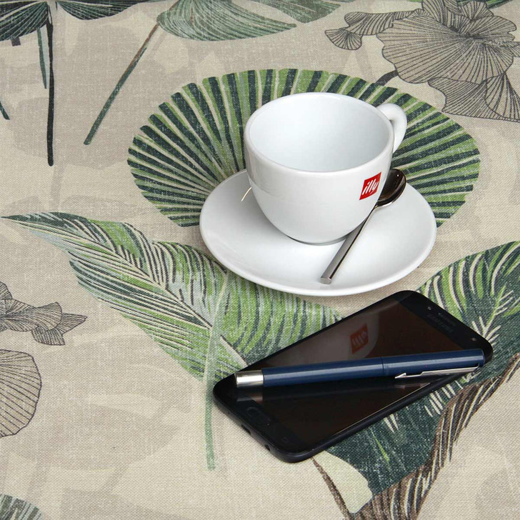 Wipe Clean Tablecloth - Digital: Kalani - Green.  Pictured with a cup and saucer, 'phone, pen and coins.
