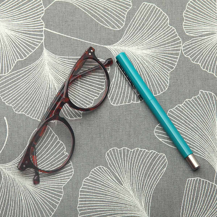 Wipe Clean Fabric. Culla: Ginkgo - pictured with a pair of glasses and a pen.