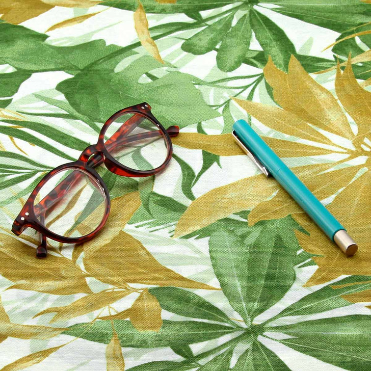 Living Tropical Green: Wipe Clean Fabric. Pictured with a pair of glasses and a pen.