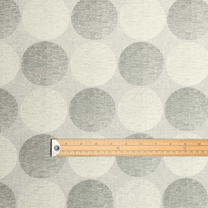 Living Circles - Grey: Wipe Clean Fabric. Pictured with a wooden metre rule to show scale