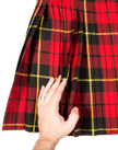 Hand touching a red plaid kilt