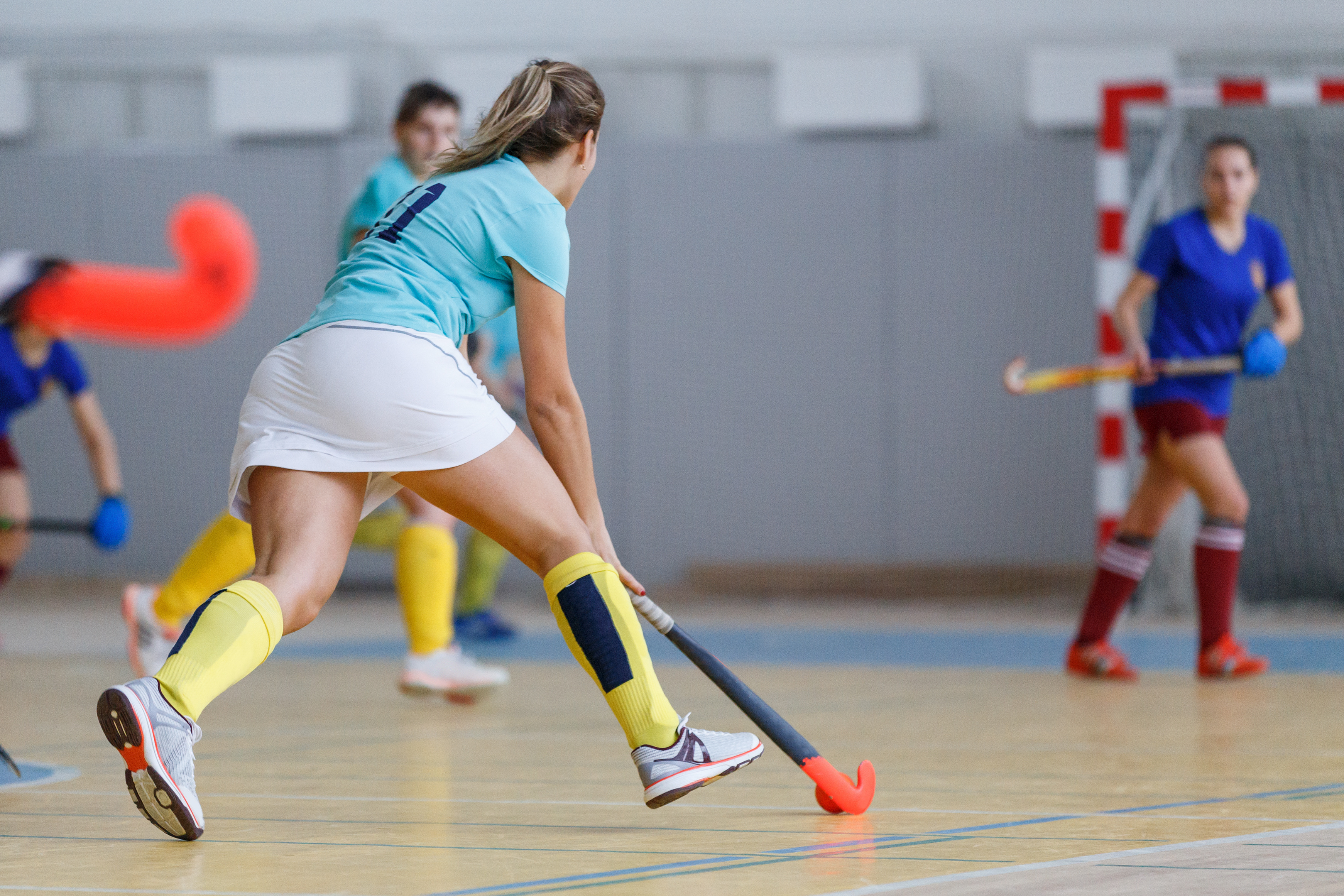 A hockey player in attack during an indoor match.