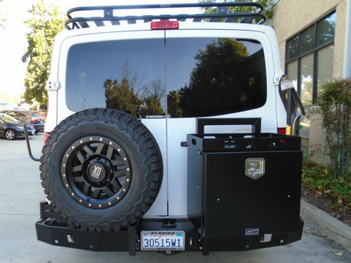 A gloss white Nissan NV van with an off-road rear bumper and accessories from Aluminess Products.