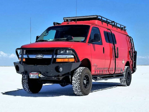 A red Chevy Express van with a surf board mount pole and side ladder from Aluminess Products.