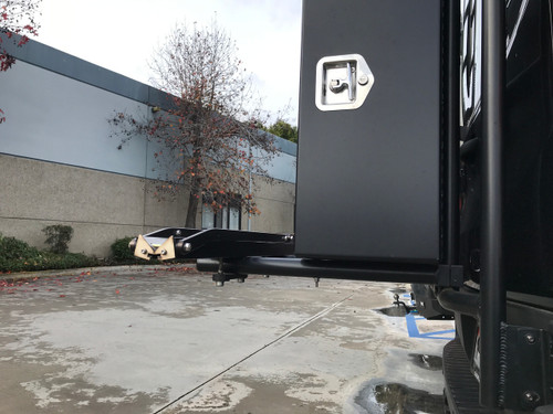 Close-up picture of a van featuring Aluminess Rear Door Rack Bolt-On Support Posts holding a box.