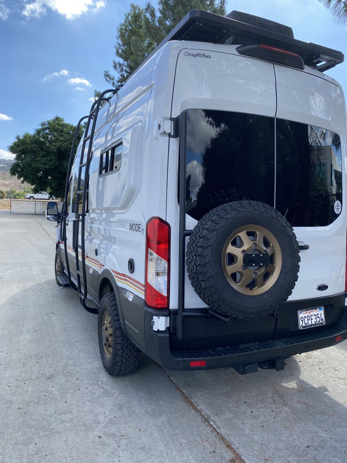 Rear view of a white Ford Transit van featuring Aluminess Driver Side Rear Door Box/Tire Rack.