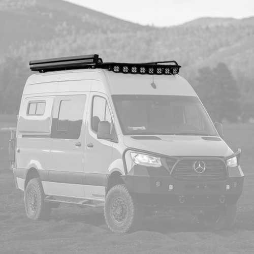Mercedes Sprinter van is parked in the desert featuring Aluminess Explorer Roof Rack.