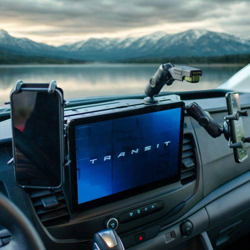 Dash Mount System for Transit vans holding a tablet and phone inside a van with a scenic lake view.