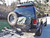 Rear view of an black Excursion van on the wild featuring Aluminess Rear Bumper.