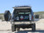 Side view of an black Excursion van on the wild featuring Aluminess Rear Bumper.