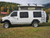 White Ford E-Series van equipped with a black side ladder.