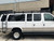 White Ford Excursion SUV featuring Aluminess Weekender Roof Rack parked on the street.