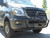 Close-up picture featuring Aluminess Front Receiver Hitch parked on a Mercedes Sprinter van.
