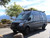 Picture of a Mercedes Sprinter van featuring Aluminess Front Receiver Hitch parked on a park.