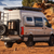 Beige Mercedes Sprinter van outfitted with several off-road accessories, parked near open canyons.