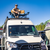 White Mercedes Sprinter van featuring an Aluminess Explorer Roof Rack parked in the street.