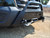 A black Ford Transit van equipped with a Baja style front winch bumper.