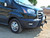 A black Ford Transit van equipped with a Baja style front winch bumper.