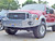 Side view picture of an Excursion van featuring Aluminess Front Bumper parked on the street.