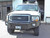Picture of an Excursion van featuring Aluminess Front Bumper parked on the street.