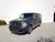 A matte black Nissan NV van with a slimline front winch bumper from Aluminess Products.