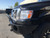 A gloss black Nissan NV van with a slimline front winch bumper from Aluminess Products.