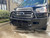 Close-up side view of a black Transit van featuring Aluminess Front Bumper parked on the street.