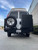 Rear view of a white Express van featuring Aluminess Rear Bumper parked on the street.