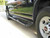 Close-up picture of Aluminess all-aluminum Nerf Bars on a Black Chevy Express parked on the street.