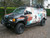 A mural-wrapped Ford E-series van with a set of nerf bars from Aluminess Products.