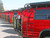Red Ford E-Series vans equipped with a black side ladder.