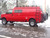 Red Chevy Express van with an all-aluminum side ladder from Aluminess Products on the driver side of the vehicle.