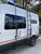 Side view of a white Ford Transit van featuring Aluminess Surf Pole.