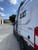 Side view of a white Ford Transit van featuring Aluminess Surf Pole.