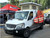 White Mercedes Sprinter van with a surfboard mounted on the side of the vehicle using a Surf Pole and Side Ladder from Aluminess Products.