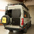 Pearl white Mercedes Sprinter van featuring Aluminess Rear Door Plates parked.